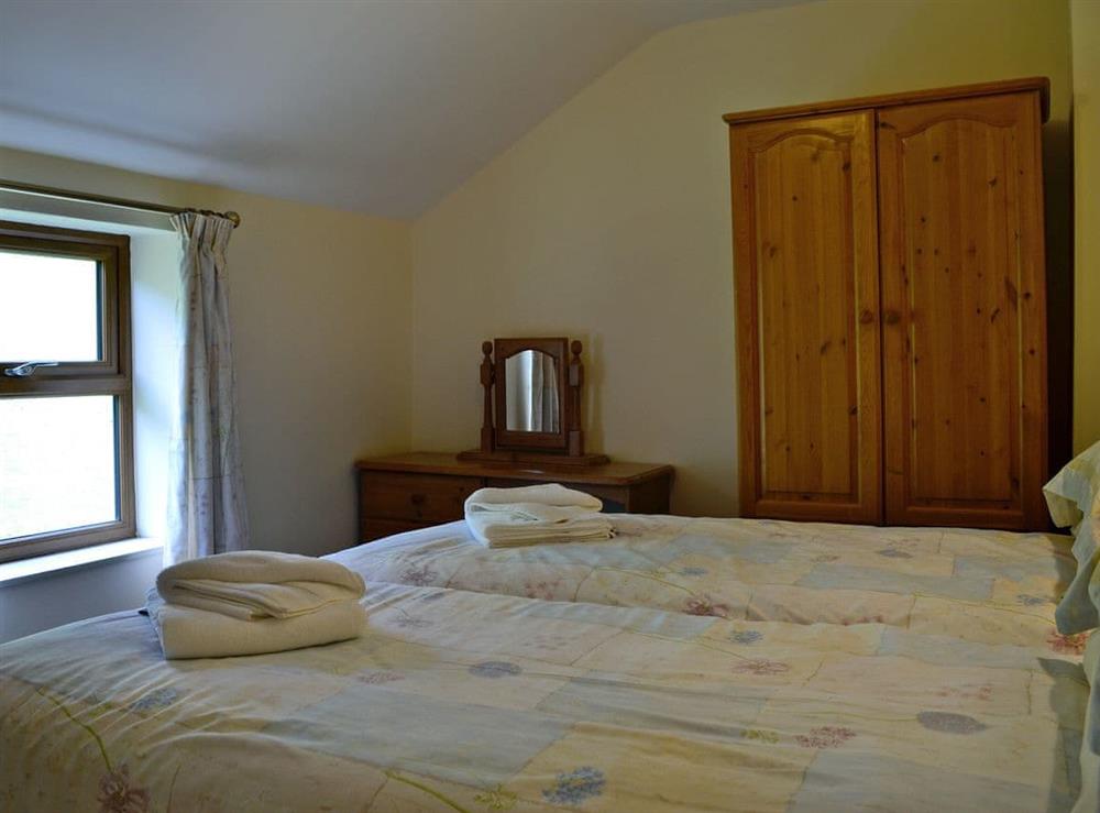 Charming twin bedroom (photo 2) at Grajo Cottage, 