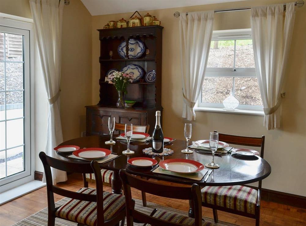 Dining room with French doors leading to garden at Dolfran Bach in Dolwen, near Betws-yn-Rhos, Abergele, Clwyd