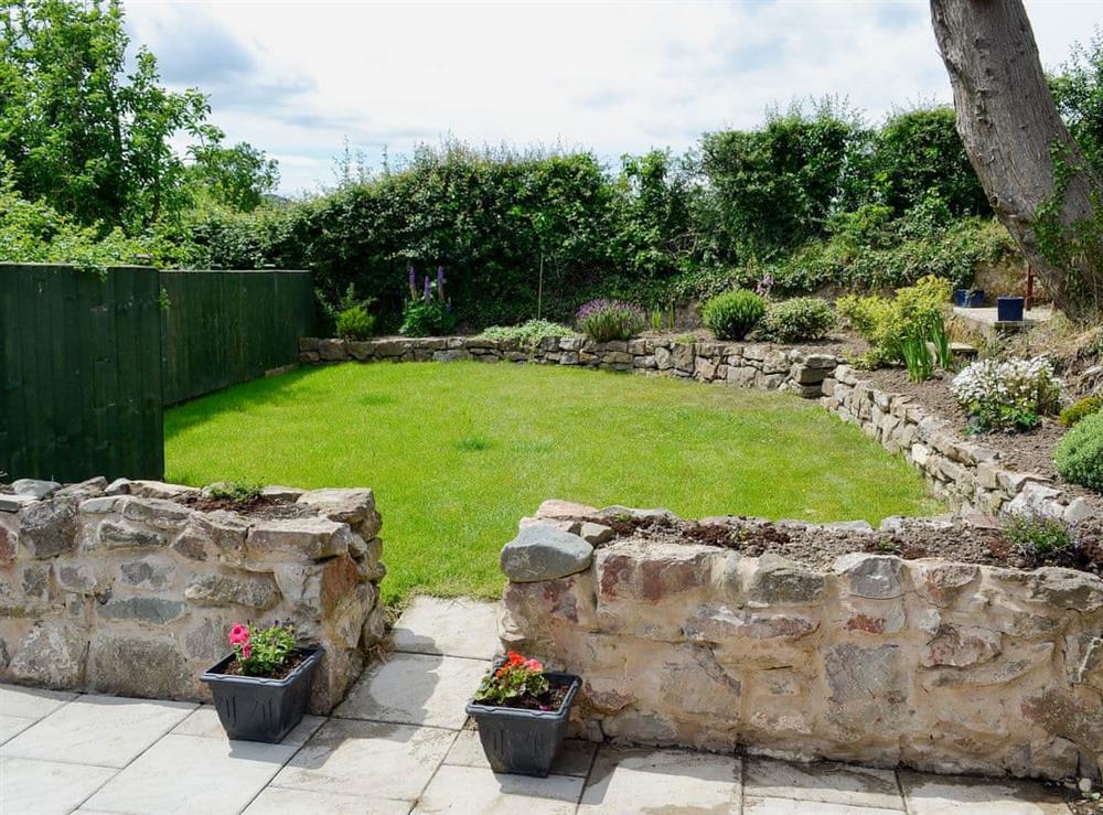 Enclosed lawned garden with patio and garden furniture at Dolfran Bach in Dolwen, near Betws-yn-Rhos, Abergele, Clwyd