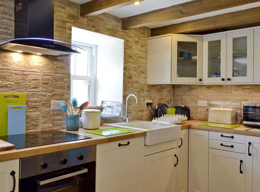 Well-equipped kitchen at Snuggle Cottage, 