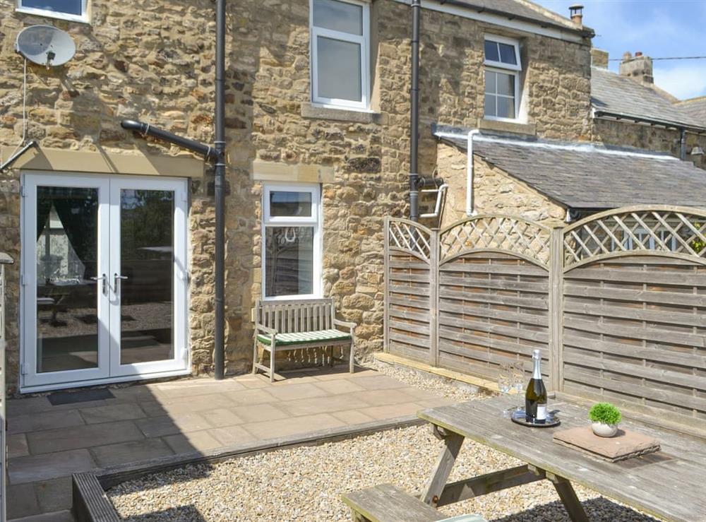 Patio to the rear of the holiday home at Dollys Cottage in Ovington, Northumberland