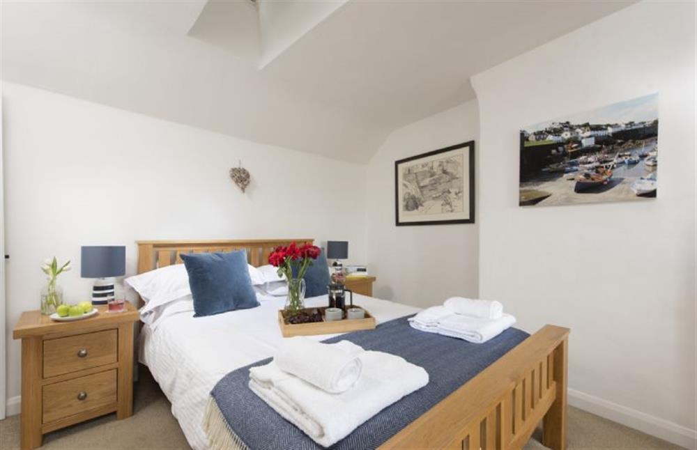 Bedroom one with a 4’6 double bed at Dolor Cottage, Coverack