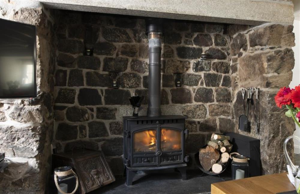 Relax in front of a roaring wood burning stove surrounded by exposed stonework at Dolor Cottage, Coverack