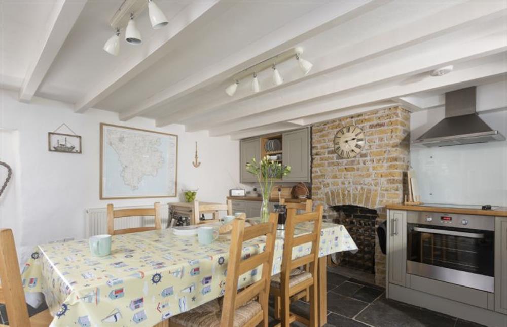 The dining table is set in the heart of the kitchen at Dolor Cottage, Coverack