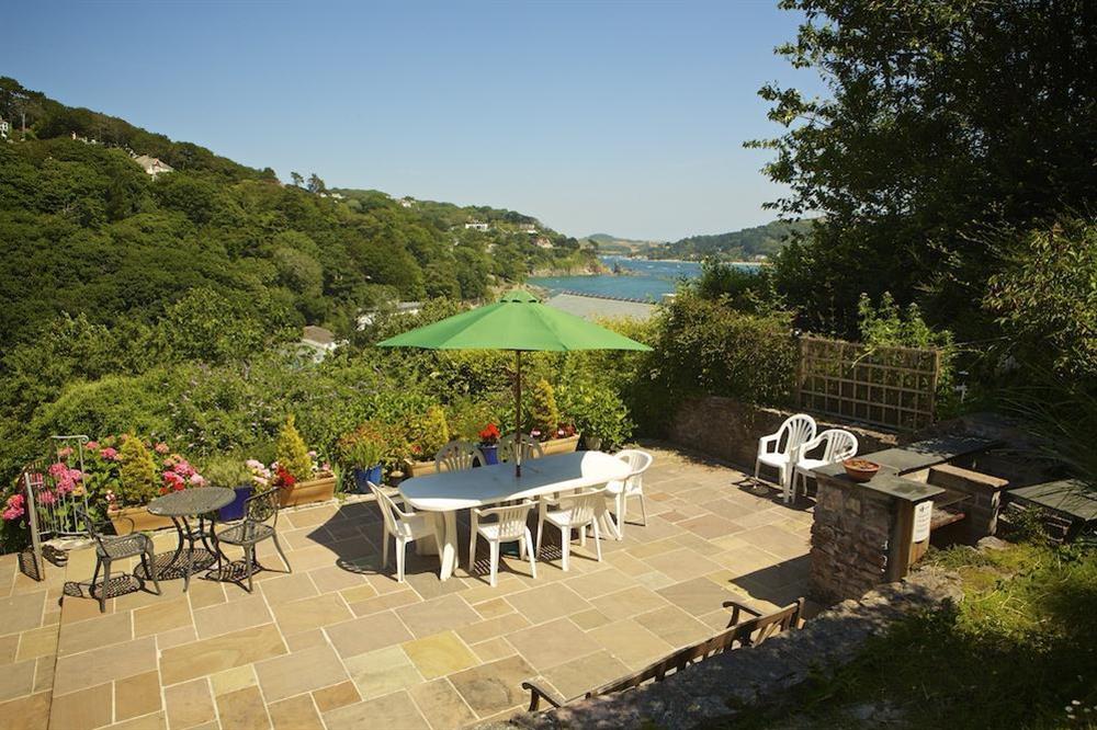 Large terrace, overlooking the estuary with table and chairs seating eight at Dolphins in South Sands, Salcombe