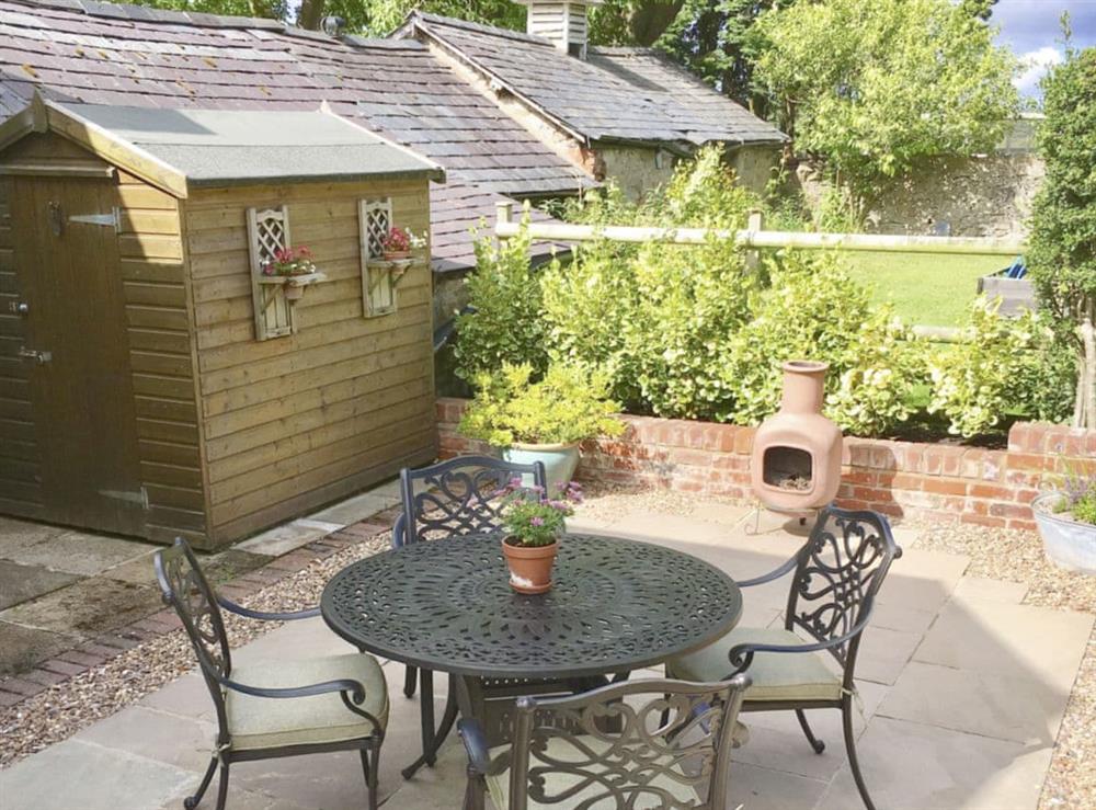 Paved patio area with outdoor furniture at Donadea Cottage in Babell near Holywell, Clwyd
