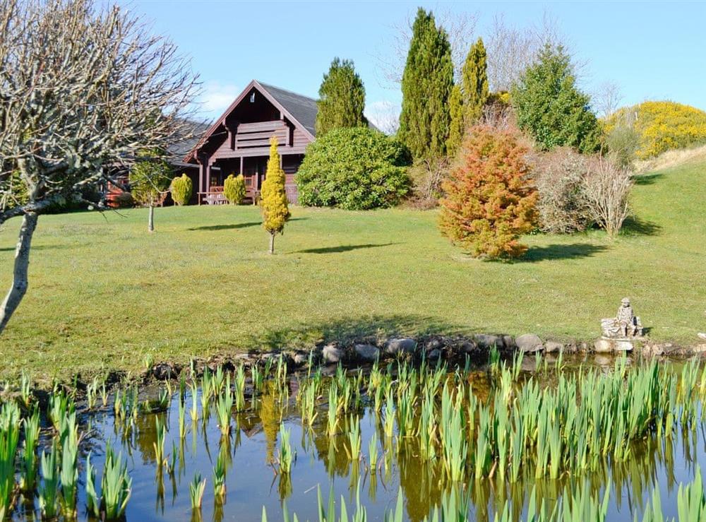 Peaceful landscaped gardens with pond at Dontra Log Chalet in Upper Banavie, near Fort William, Inverness-Shire