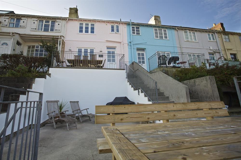 Terrace with wooden table, benches and sunloungers (photo 4) at Dory Cottage in , Salcombe