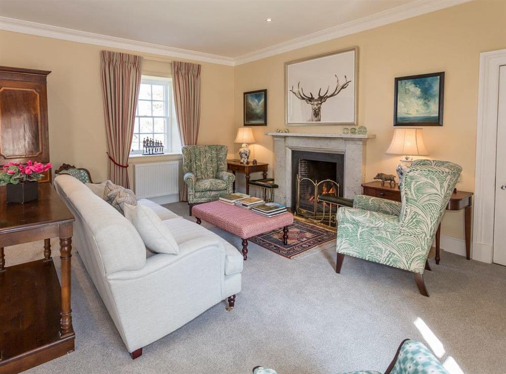 Impressive drawing room with open fire at The House of Machrie, 