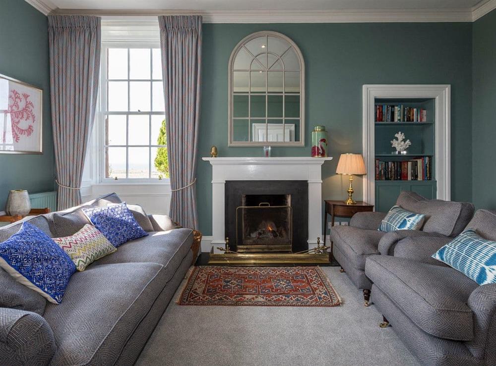 Stylishly furnished sitting room with open fire at The House of Machrie, 