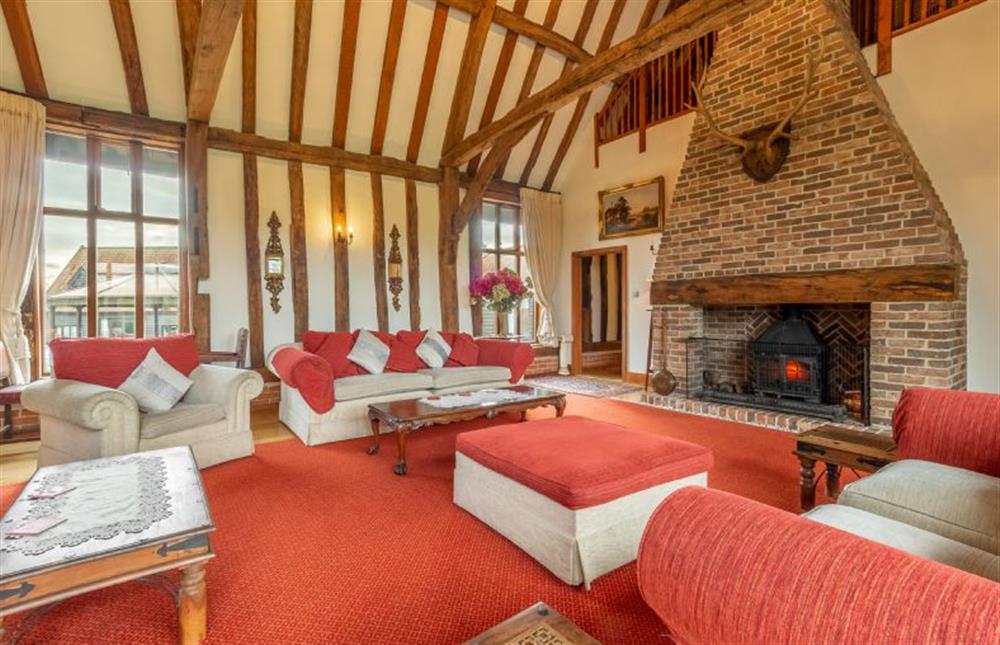 Sitting room with vaulted ceiling and large inglenook fireplace at Doves Barn, Needham Market