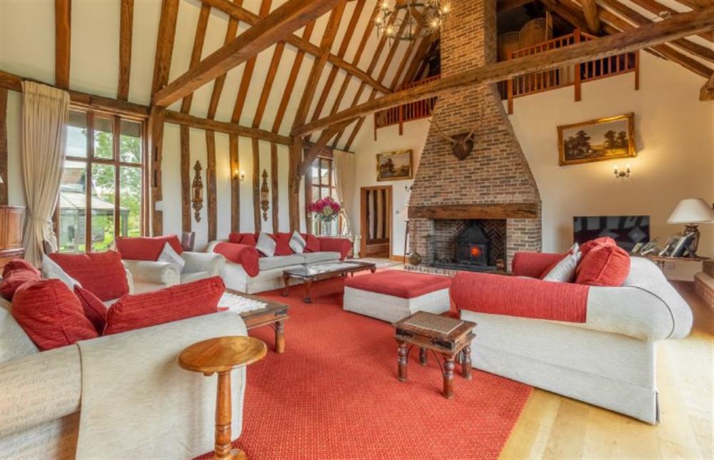 Sitting room with vaulted ceiling and wood burning stove at Doves Barn, Needham Market