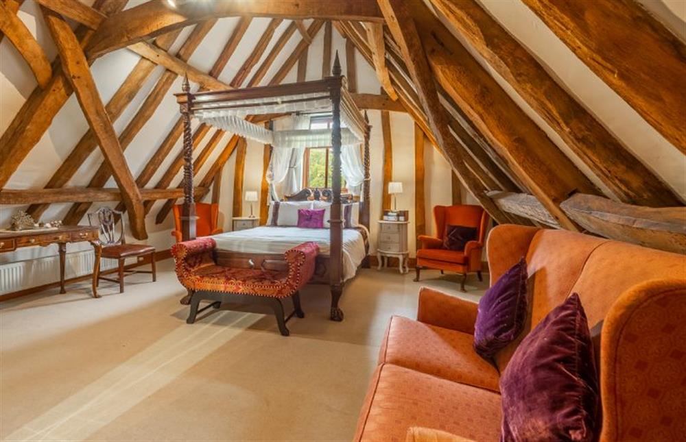 The master bedroom with king-size four poster bed at Doves Barn, Needham Market