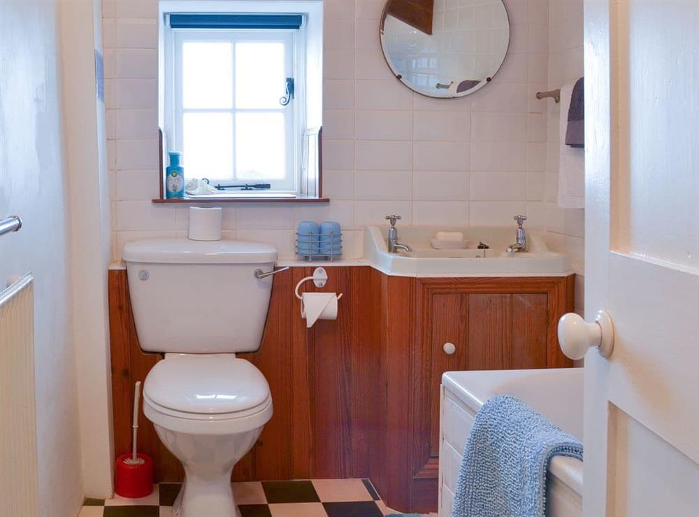 Bathroom with shower over the bath at Downhouse Cottage in Delabole, near Tintagel, Cornwall
