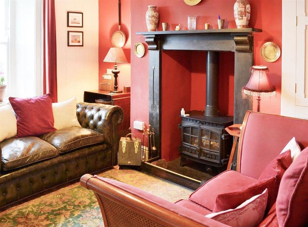 Cosy and comfortable living room with wood burner at Downhouse Cottage in Delabole, near Tintagel, Cornwall