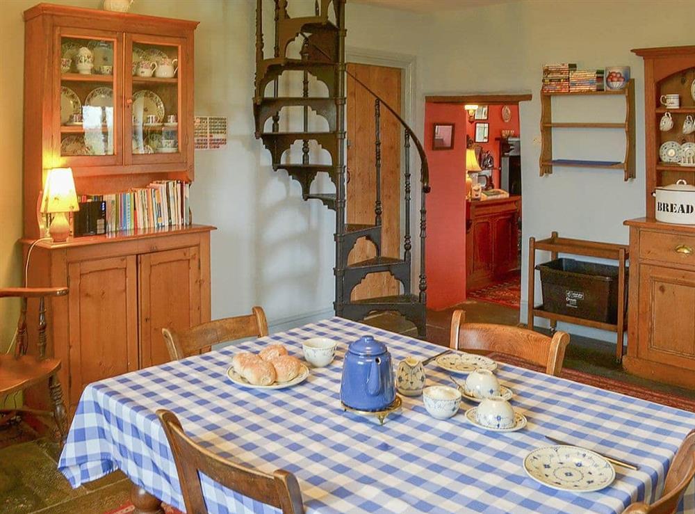 Country style kitchen with spiral staircase to upper level at Downhouse in Trebarwith, Delabole, Cornwall., Great Britain