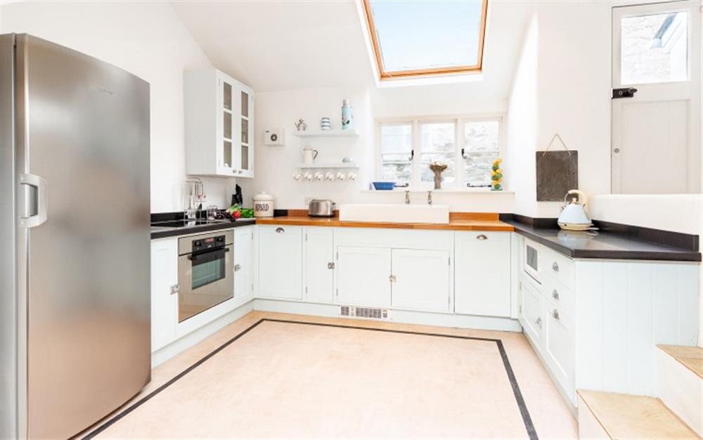 The spacious well equipped kitchen at Downsteps Beach House in Torcross