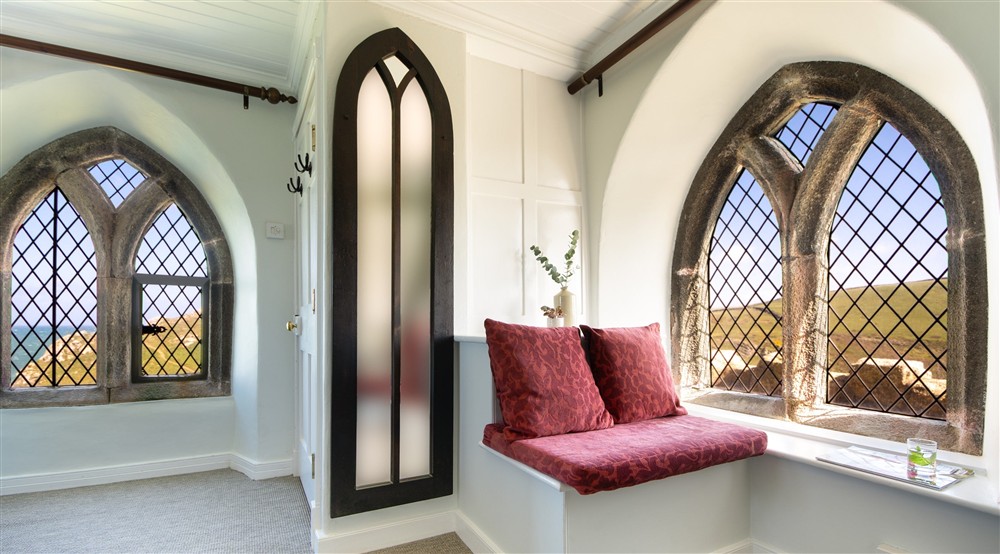 The bench seating in the bedroom at Doyden Castle in Port Quin, Cornwall