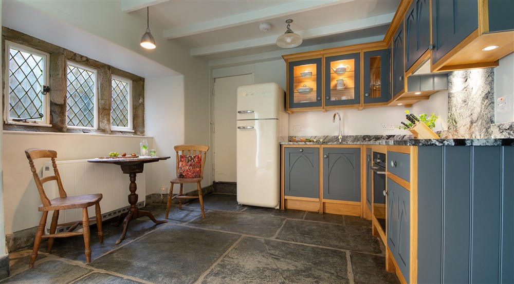 The breakfast table in the kitchen at Doyden Castle in Port Quin, Cornwall