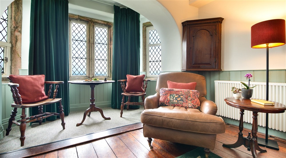 The dining area in the sitting room at Doyden Castle in Port Quin, Cornwall