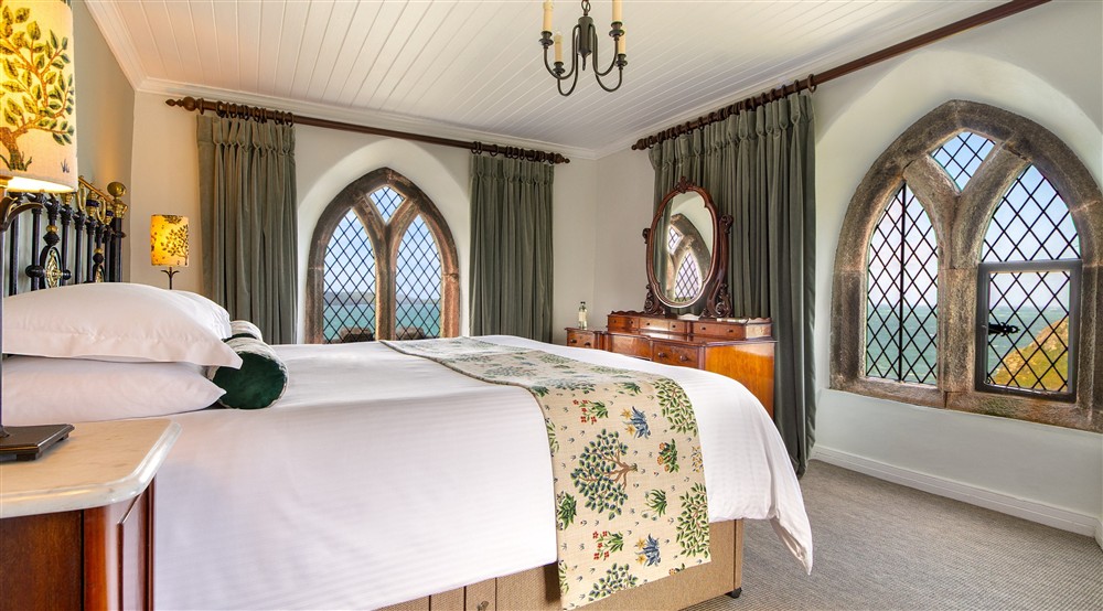 The double bedroom with views from three sides at Doyden Castle in Port Quin, Cornwall