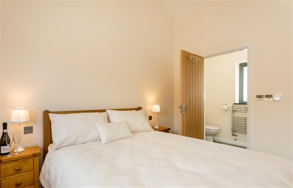 The master bedroom with door to en-suite shower room at Dragon Barn, Tintagel