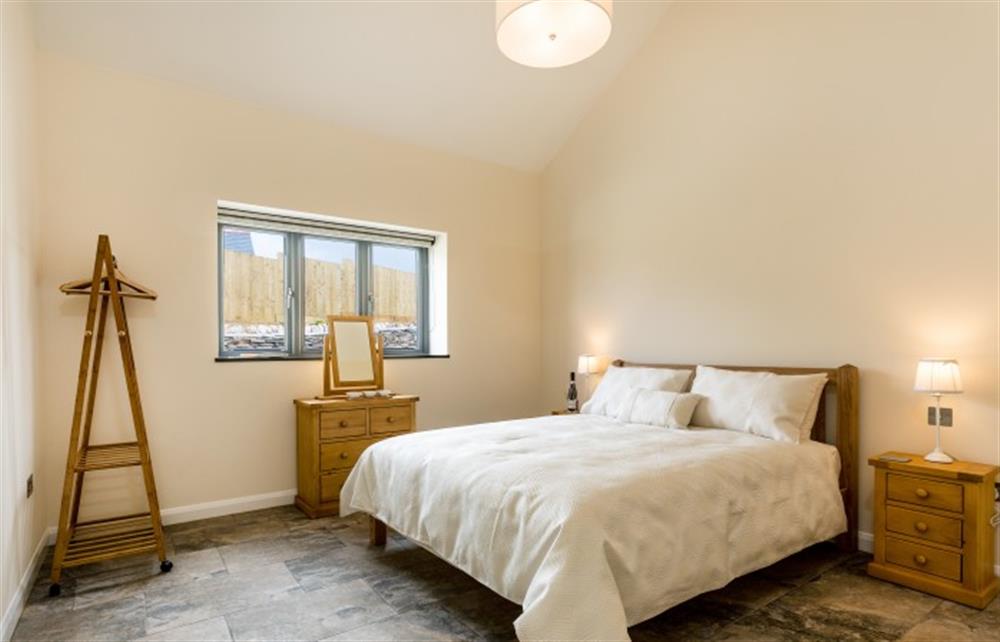 The master bedroom with the en-suite shower room at Dragon Barn, Tintagel