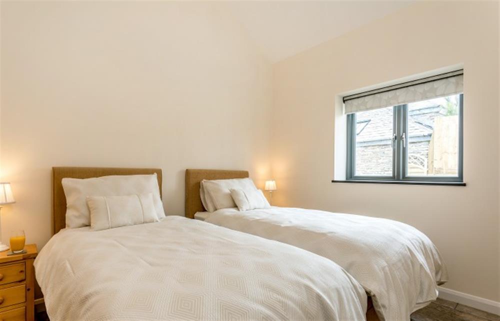 The very comfortable twin bedroom, which can be linked to a super king size bed at Dragon Barn, Tintagel