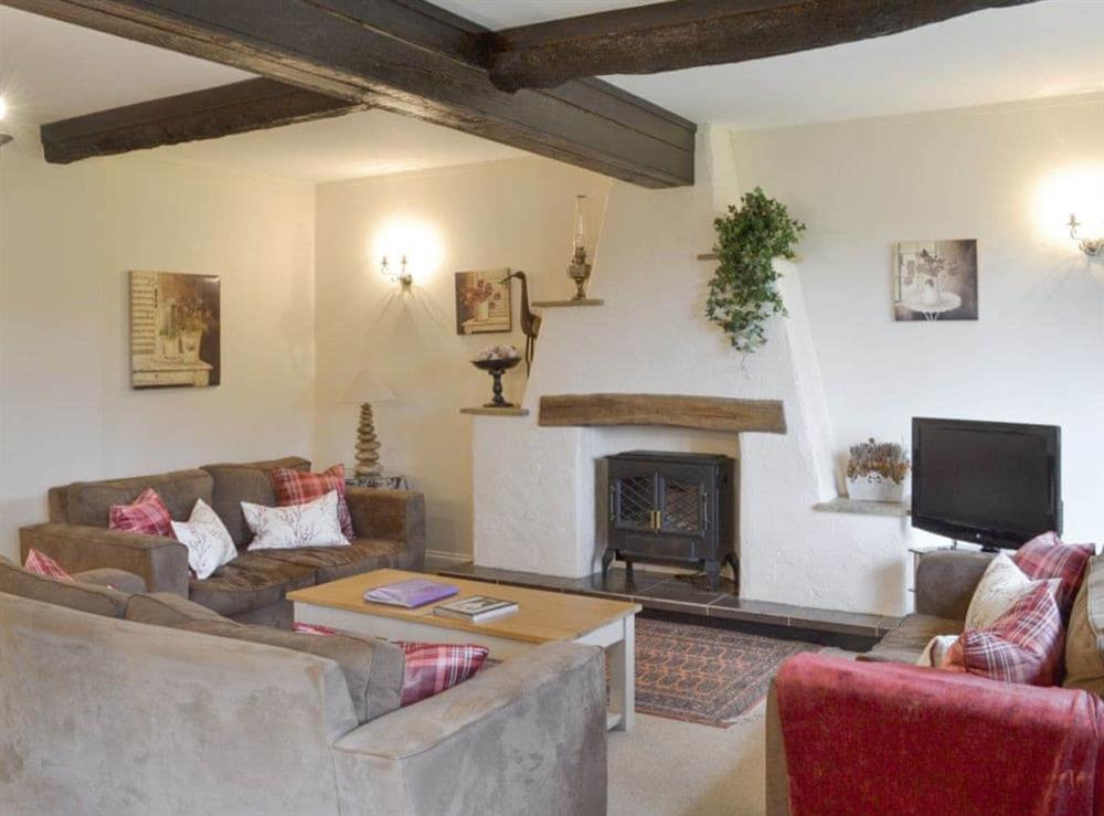 Characterful living room with exposed wood beams at Dray Cottage in East Allington, Nr. Totnes, Devon., Great Britain