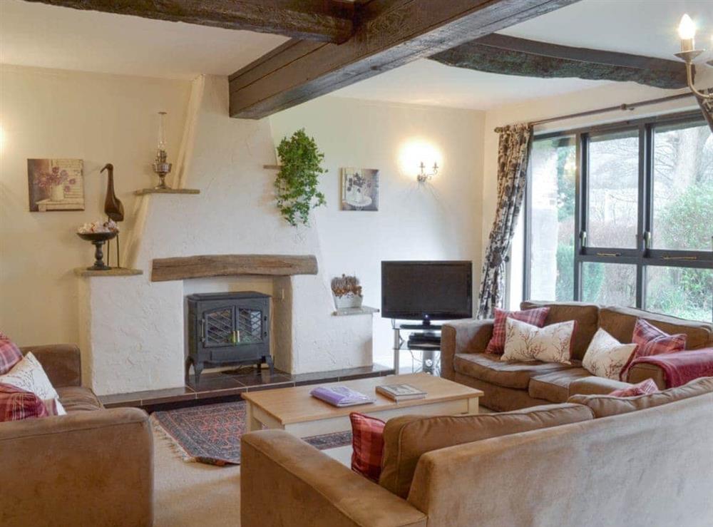 Welcoming living room with wood burner at Dray Cottage in East Allington, Nr. Totnes, Devon., Great Britain