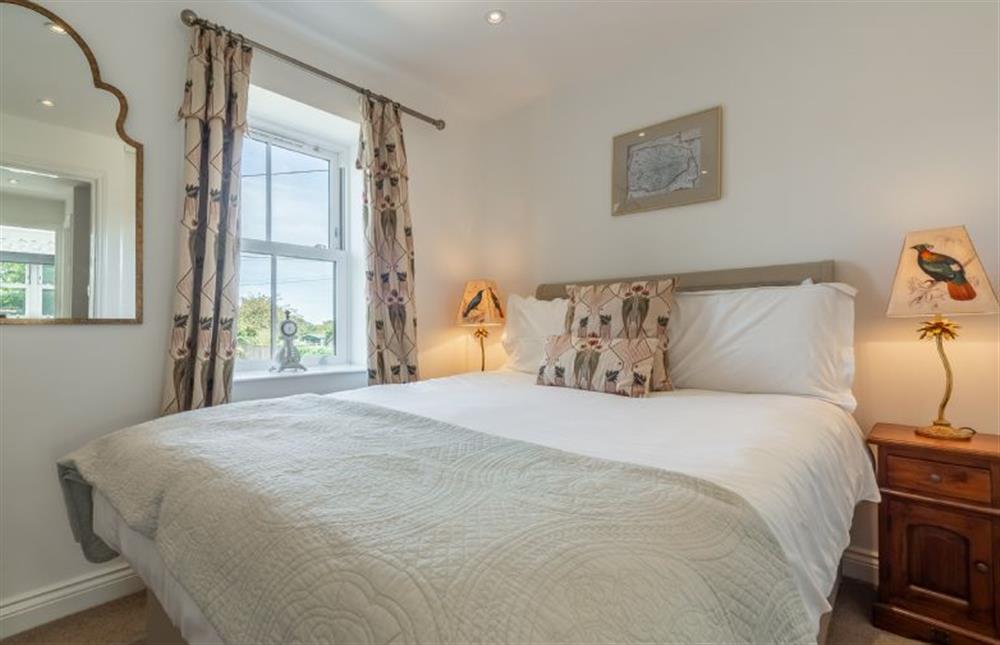 The master bedroom has a double bed at Driftwood Cottage, Brancaster near Kings Lynn