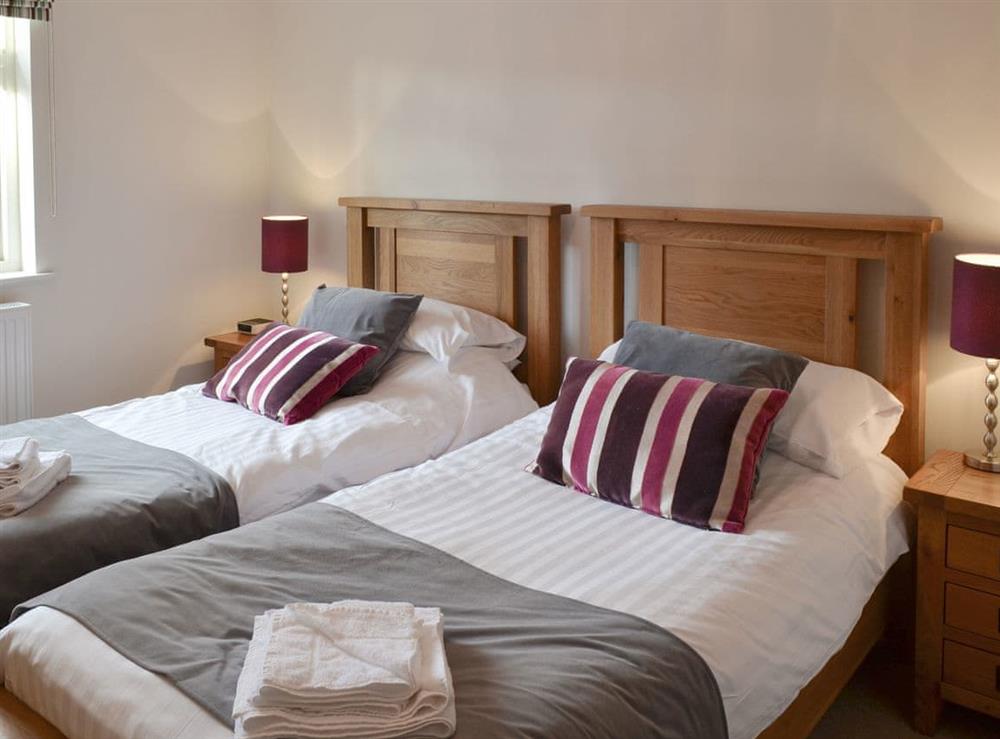 Stylish twin bedroom at Driftwood Cottage in Newton-by-the-Sea, near Alnwick, Northumberland