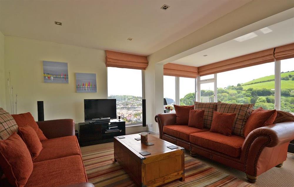 The sunny dual aspect lounge, with patio doors leading out to the top balcony at Driftwood, Dartmouth