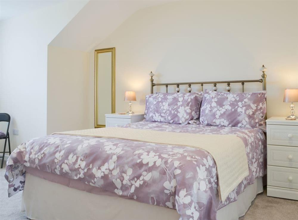 Beautiful bedroom with antique style bed at Driftwood in Port Isaac, Cornwall