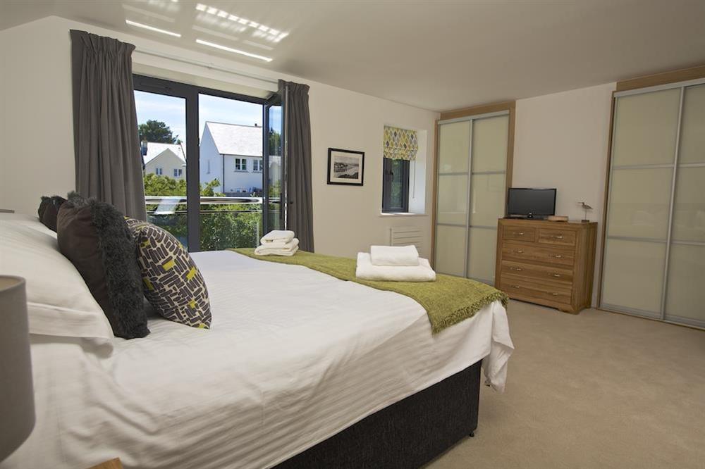 First floor master bedroom suite with super-King size bed and en suite shower room at Driftwood in , Salcombe
