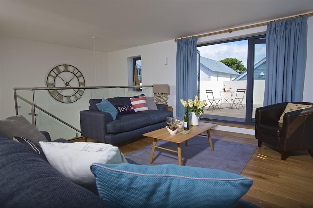 First floor sitting room with doors out to the upper terrace at Driftwood in , Salcombe