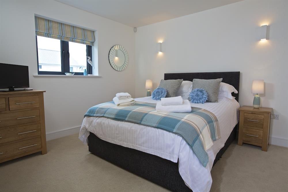 Ground floor bedroom with King-size bed and en suite shower room at Driftwood in , Salcombe