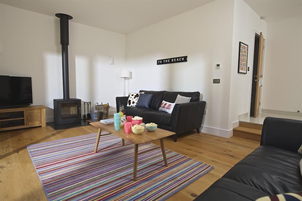 Ground floor family room with wood burning stove at Driftwood in , Salcombe