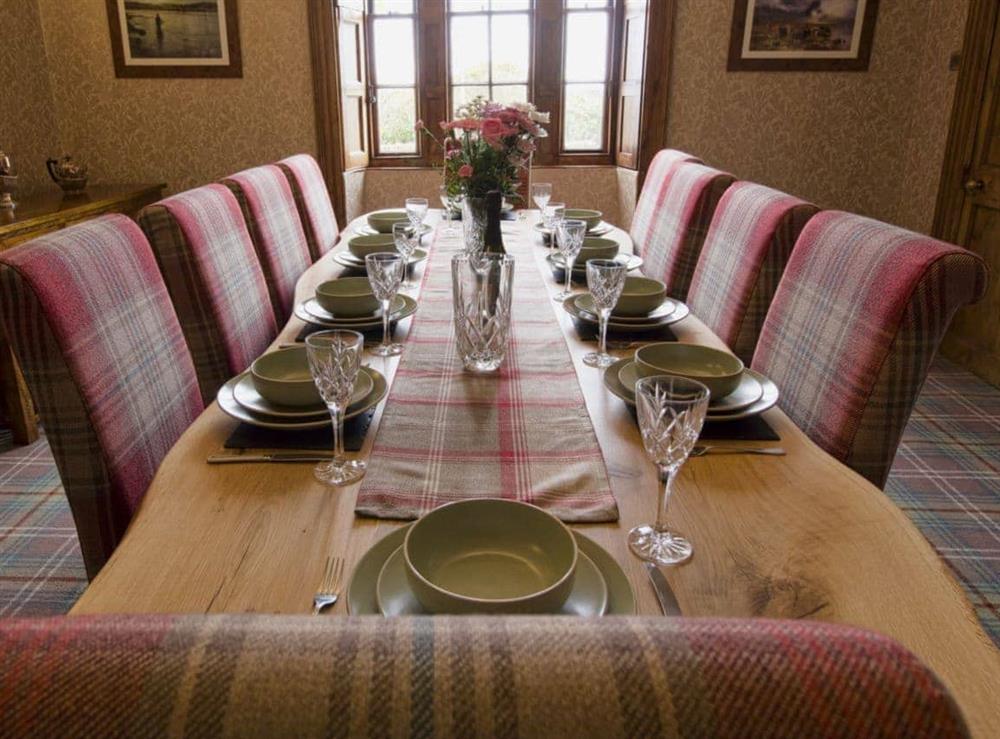 Elegant dining room with open fireplace (photo 2) at Drummuie House in Golspie, Sutherland