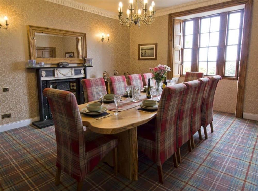Elegant dining room with open fireplace at Drummuie House in Golspie, Sutherland