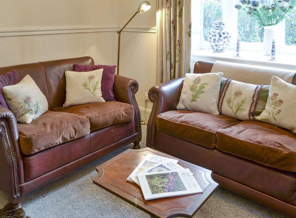 Comfy seating within living room at Duffs Lodge in Beauly, Inverness-Shire