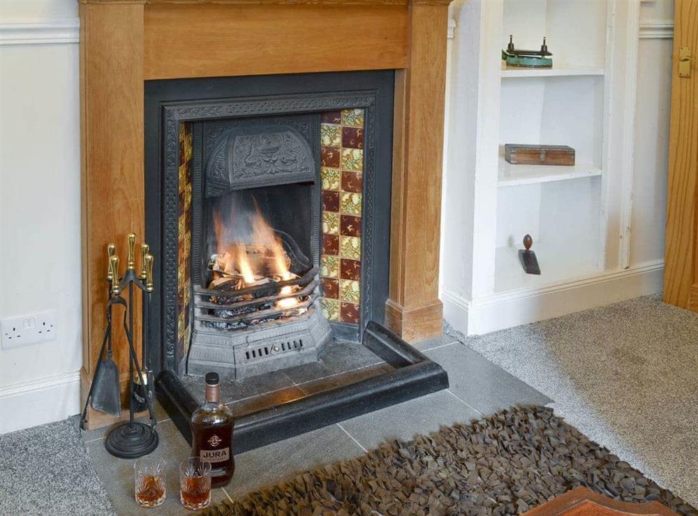 Feature fireplace within living room at Duffs Lodge in Beauly, Inverness-Shire