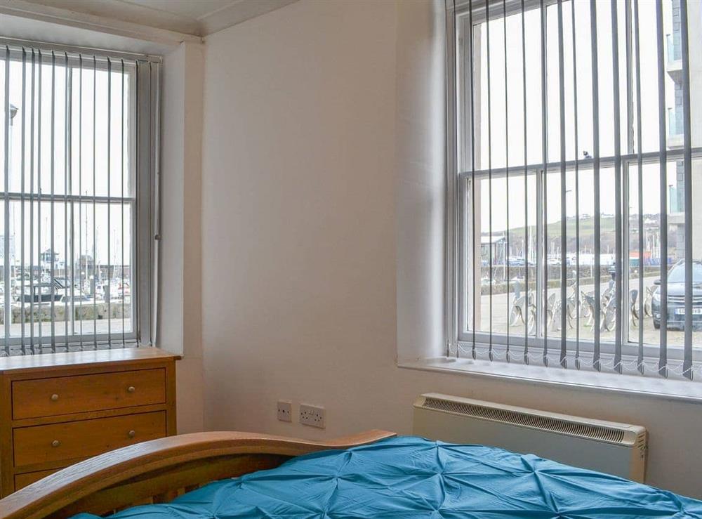 Bedroom with dual aspect views of the harbour at Duncan Square in Whitehaven, Cumbria