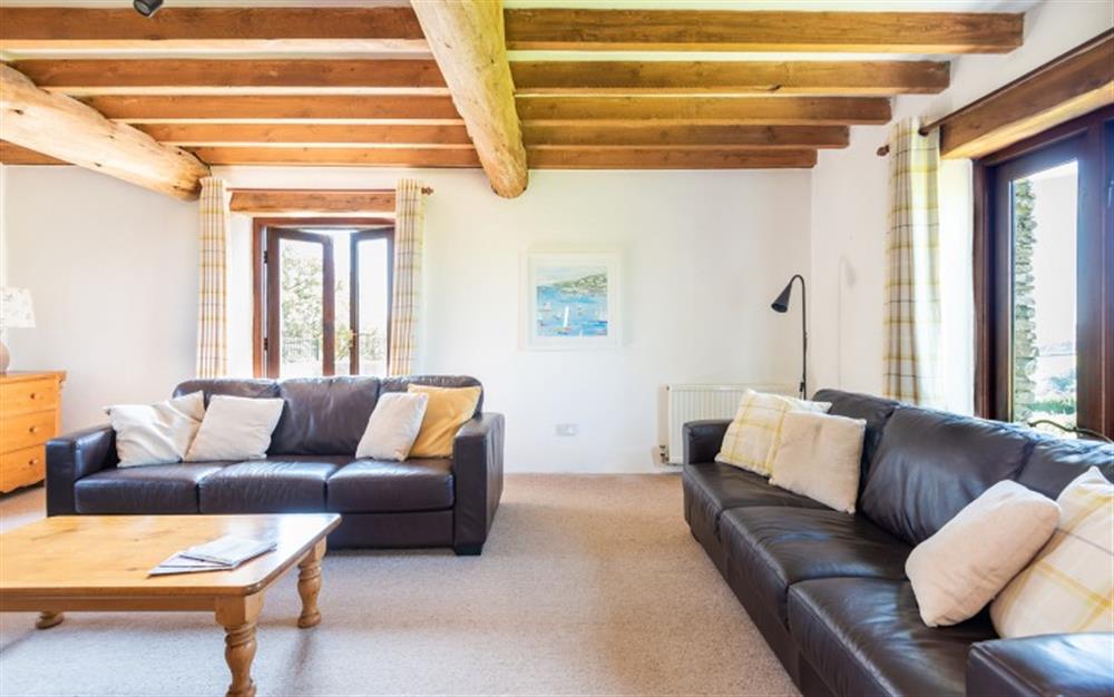 The comfortable lounge with doors to the balcony at Duncombe Barn in Sherford