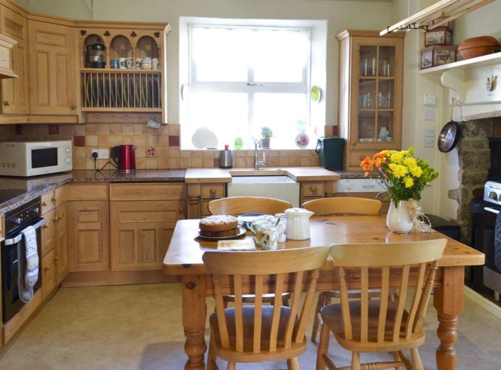 Traditional kitchen with breakfast area at Dunley Farmhouse in Bovey Tracey, near Newton Abbot, Devon
