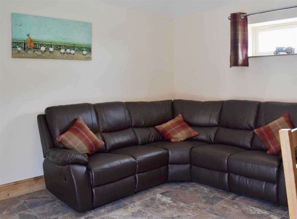 Comfortable leather sofas in the open plan living area at The Old Dairy, 
