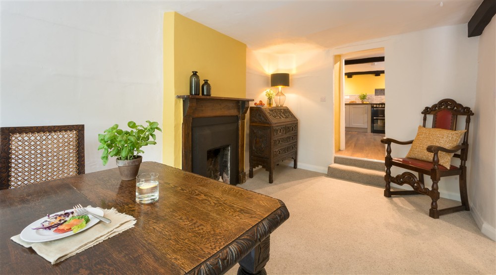 The dining room with steps up to the kitchen at Dunster Keeper's House in Dunster, Somerset