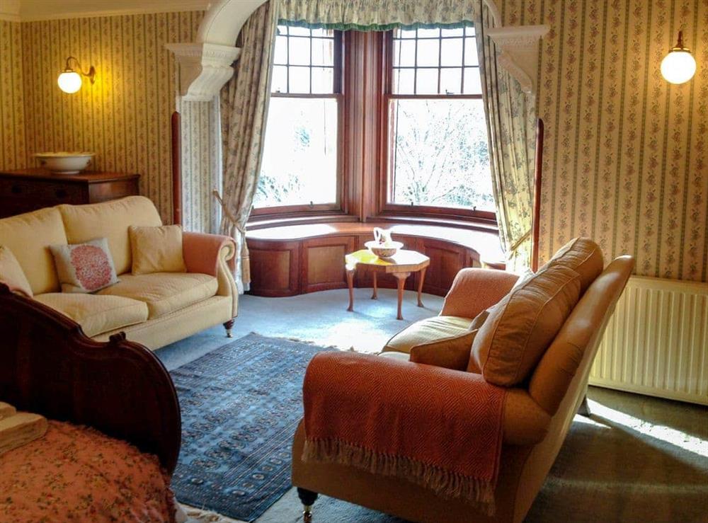 Double bedroom with feature fireplace and river views at Dunvarlich House in Aberfeldy, Perthshire., Great Britain