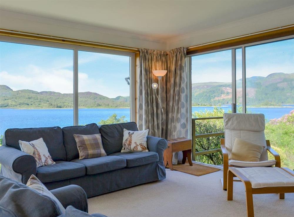 Living room with large feature windows to take advantage of the stunning views at Dunyvaig in Colintraive, near Rothesay, Argyll
