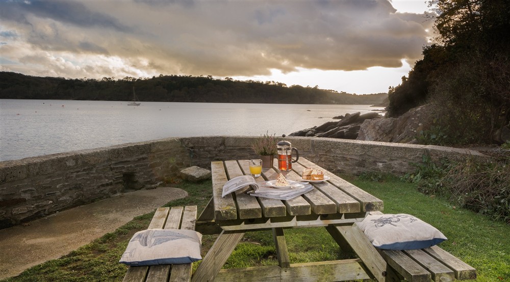 Outdoor eating area at Durgan Quay Cottage in Falmouth, Cornwall